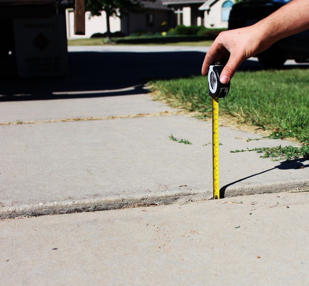 Settled concrete driveway panels before polyurethane foam lifting